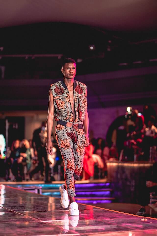 A male model walks the runway.