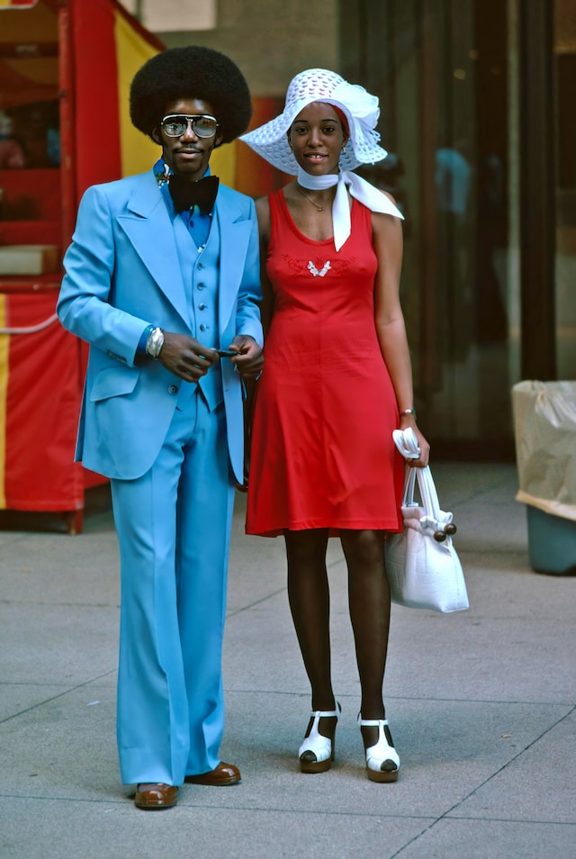 A couple on the street, garbed in typical 1970s fashion.