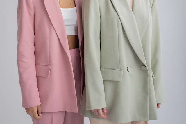 Two women wearing suits.