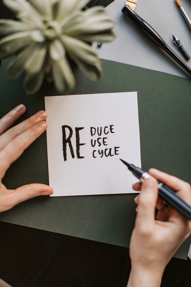 A handwritten note saying reduce, reuse, recycle.