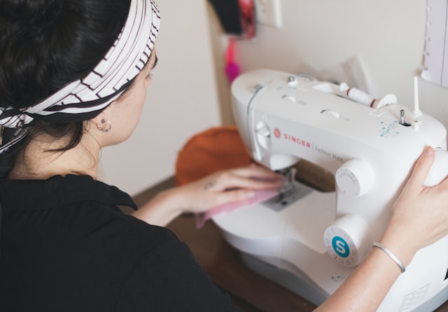 Woman using an electric sewing machine