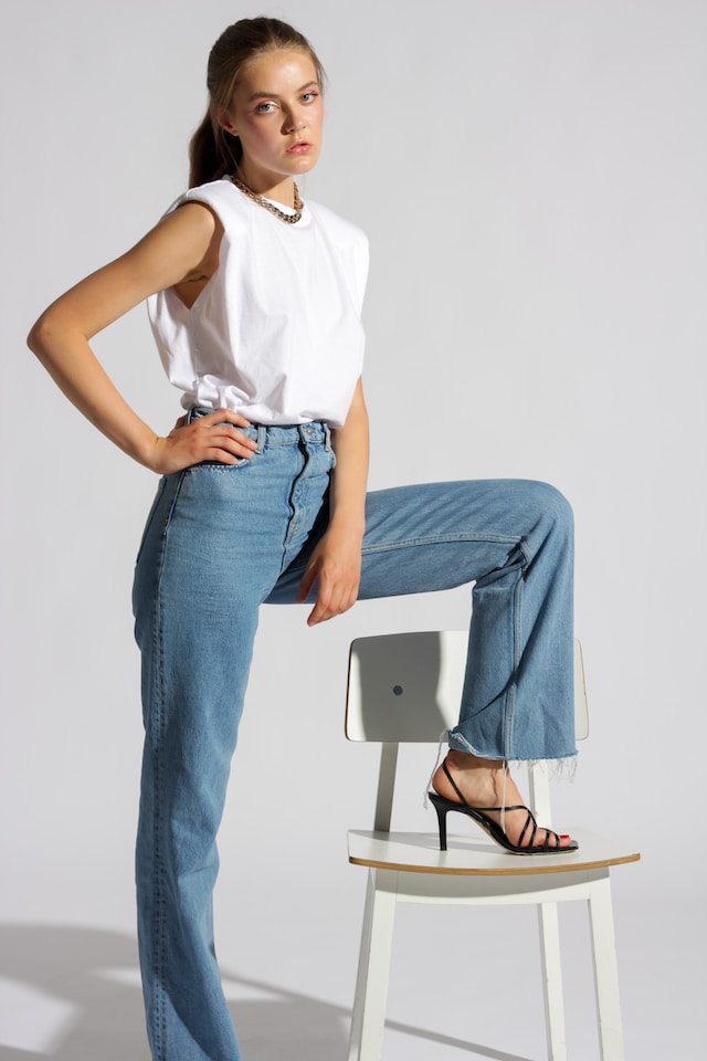 Woman in a white shirt and a [air of jeans